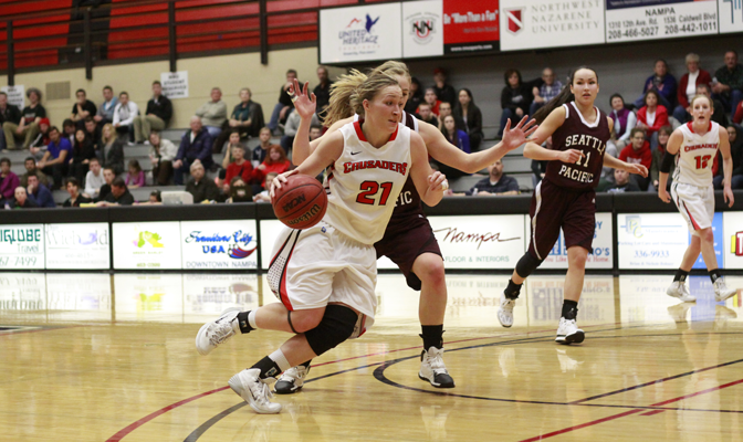 NNU senior Megan Hingston (left) scored 20 points to lead the Crusaders to their first-ever victory at Seattle Pacific and keep the team's postseason hopes alive.